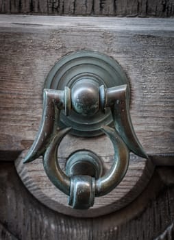 Closeup of ancient door with metallic clapper