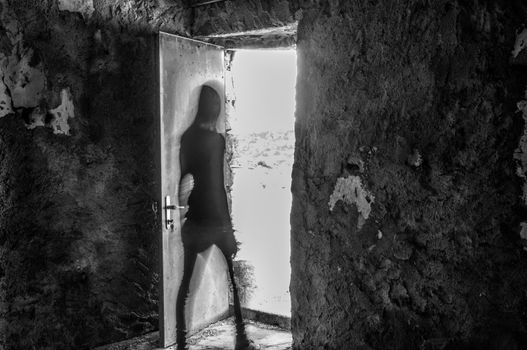 silhouette of a woman with motion blur in a ruin, like a ghost
