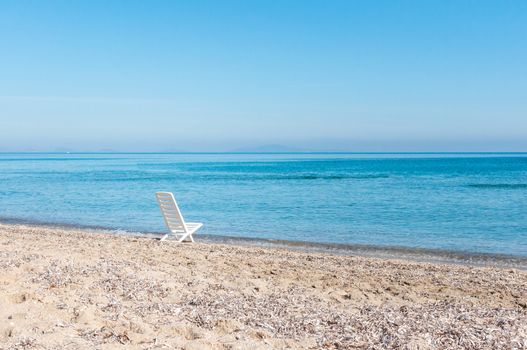 white chair on the beach in a summer day in sardinia