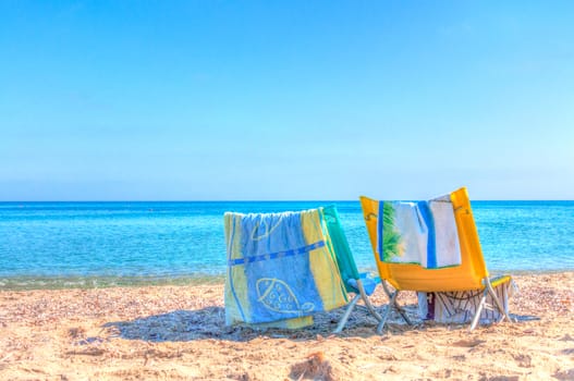 white chair on the beach in a summer day in sardinia