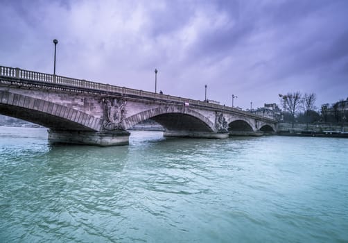 Beautiful architecture, the Bridge Austerlitz, crossing over the river Seine from Paris, France in a rainy day