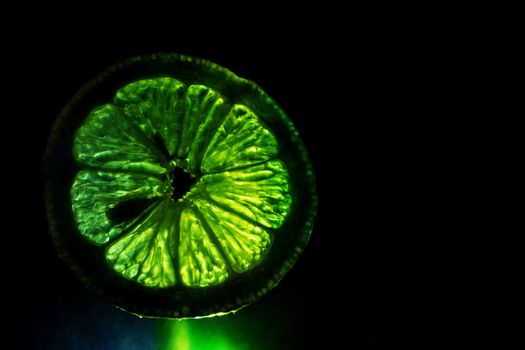 A lightpainting of a lemon in a darken background