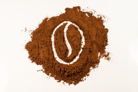 A drawing of a coffee bean in coffee powder