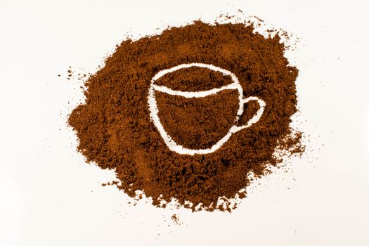 A drawing of a coffee cup in coffee powder