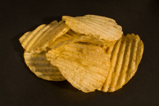 Crispy potatoes in a darken background