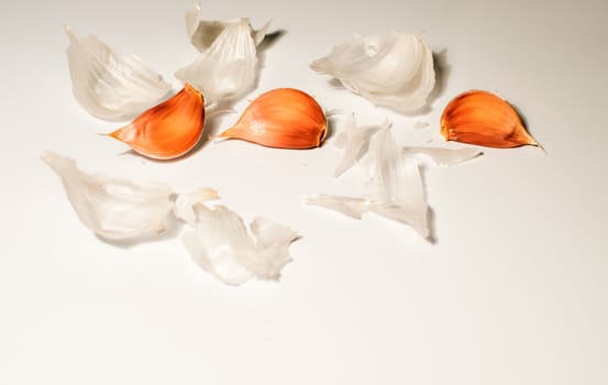 three seeds of garlic in a white background