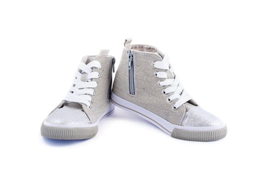 Beige jeans sneakers with white laces isolated on white

