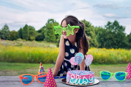 Adorable little girl with big Rock Star glasses on a birthday party, 9