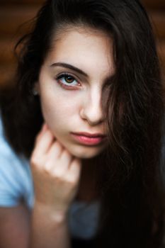 Closeup beauty portrait of young sensual beautiful brunette girl with long dark hair. 