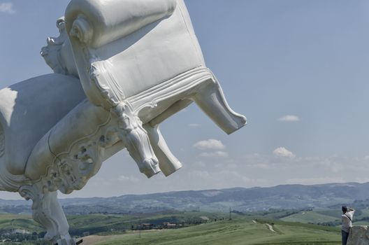 View of gigantic armchair over the Tuscan landscape