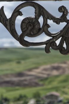 Detail of wrought iron lamp with landscape in the background