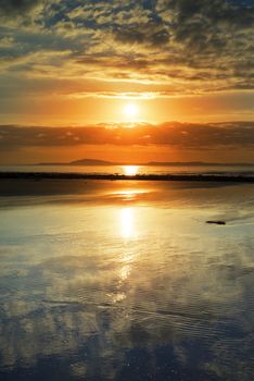 reflections at beal beach near ballybunion on the wild atlantic way ireland with a beautiful yellow sunset