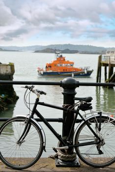 rescue lifeboat in cobh harbour county cork ireland with bicycle in foreground chained to post