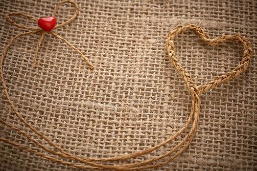 Love hearts, Valentines Day. Heart handmade, made of twine on sackcloth.  Vintage romantic style creative unusual greeting card, copyspace