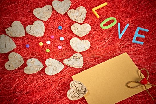 Love, Valentines Day. Word Love, hearts and note on red. Romantic style. Vivid unusual creative greeting card