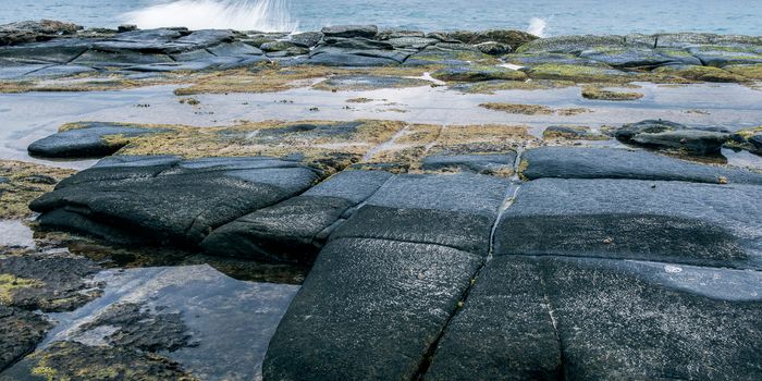 Rocks and waves at Point Cartwright beach in the afternoon. Sunshine Coast, Queensland.