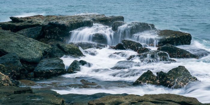 Rocks and waves at Point Cartwright beach in the afternoon. Sunshine Coast, Queensland.