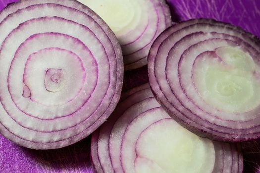 Cutten Tropea onions in a purple background