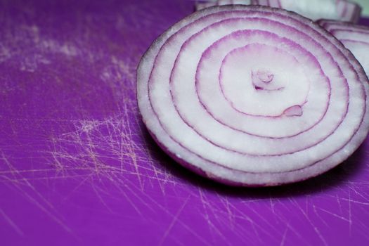 Cutten Tropea onions in a purple background