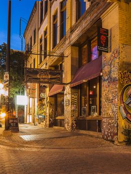 Winnipeg. Evening street. Old building with graffiti on the walls. Frame vertical. Canada.