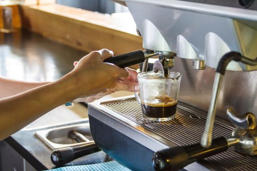 Close up of a woman working with a expresso machine