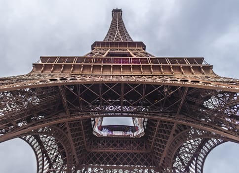 Beneath the Eiffel Tower image, from bottom to top, under a February blue sky . Picture taken in Paris, France.