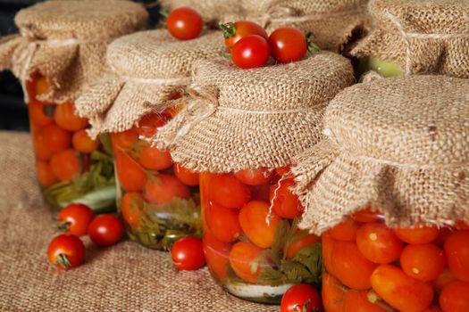 Transparent banks with marinated Cherry tomatoes. Home canning. Banks pickled tomatoes