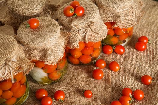 Transparent banks with marinated Cherry tomatoes. Home canning. Banks pickled tomatoes