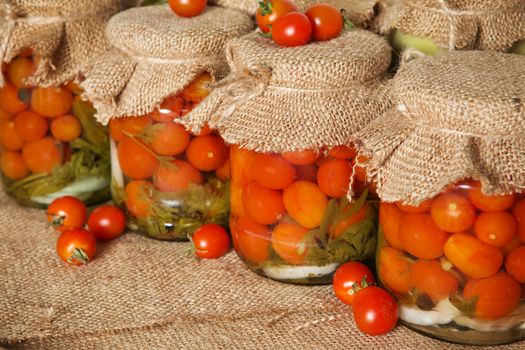 Transparent banks with marinated Cherry tomatoes. Home canning. Banks pickled tomatoes