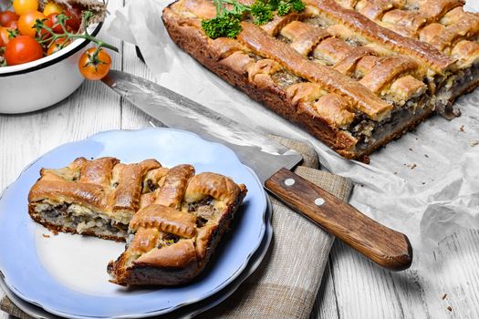 Traditional meat pie on the kitchen table on a light background