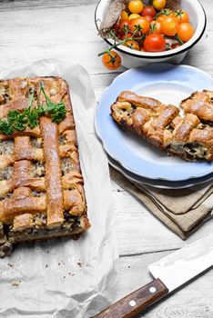 Traditional meat pie on the kitchen table on a light background