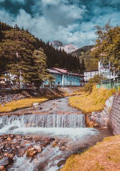 mountain river flowing through village in the Alps