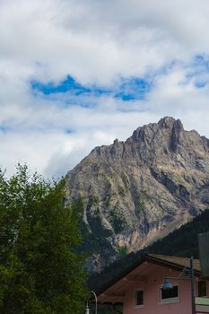 house on a background of mountains in the Alps