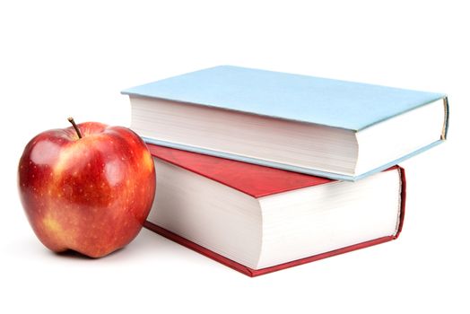 books and red apple isolated on white background