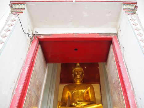 Golden buddha statue indoor in Thailand.