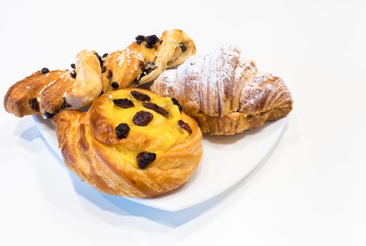 Brioches on white plate,italian breakfast, white background.