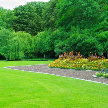 Summer garden with lawn and flower garden