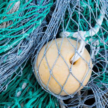 Abstract background with a pile of fishing nets ready to be cast overboard for a new days fishing