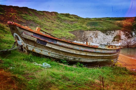 Old unused fishing boat at offshore in Flamborough bay UK, used color effects