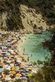 Lefkada island, Agiofilli beach, Greece - August 29 2016: Summer holidays, many people on the beach, sea swimming