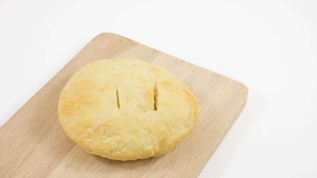 The Taiwanese sun cake (milk butter pastry) on the brown wooden plank.