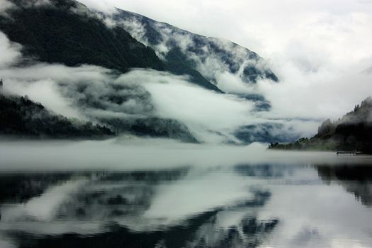 View to a misty Fjærlandsfjord. Fjærland and the sognefjord was among the destinations of early tourism in Norway. One of the famous people who visited Fjærland in de early 1900s was Kaiser Wilhelm of Germany.