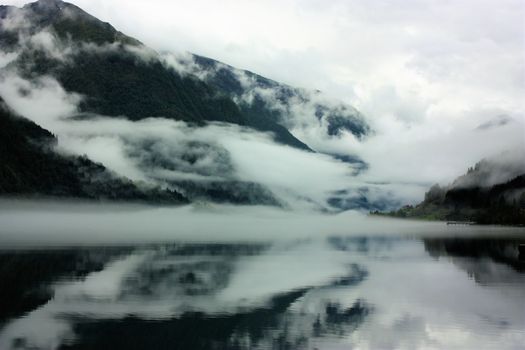 View to a misty Fjærlandsfjord. Fjærland and the sognefjord was among the destinations of early tourism in Norway. One of the famous people who visited Fjærland in de early 1900s was Kaiser Wilhelm of Germany.