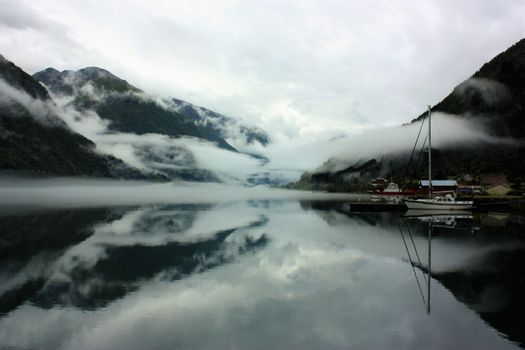 View to a misty Fjærlandsfjord. Fjærland and the sognefjord was among the destinations of early tourism in Norway. One of the famous people who visited Fjærland in de early 1900s was Kaiser Wilhelm of Germany.