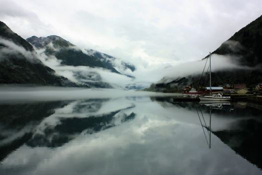 View to a misty Fjærlandsfjord. Fjærland and the sognefjord was among the destinations of early tourism in Norway. One of the famous people who visited Fjærland in de early 1900s was Kaiser Wilhelm of Germany.