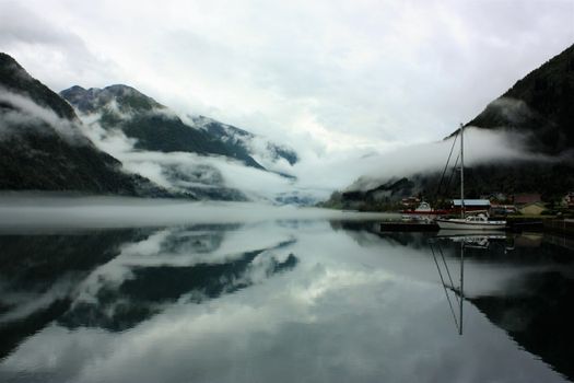 View to a misty Fjærlandsfjord. Fjærland and the sognefjord was among the destinations of early tourism in Norway. One of the famous people who visited Fjærland in de early 1900s was Kaiser Wilhelm of Germany.