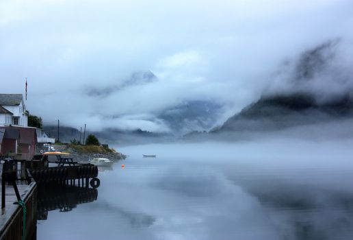 View to a misty Fjærlandsfjord. Fjærland and the sognefjord was among the destinations of early tourism in Norway. One of the famous people who visited Fjærland in de early 1900s was Kaiser Wilhelm of Germany.