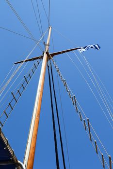 Mast of Sailing boat without sails and a blue sky