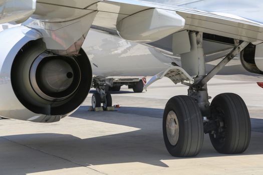 Close up of aircraft wheel and engine at the tarmac