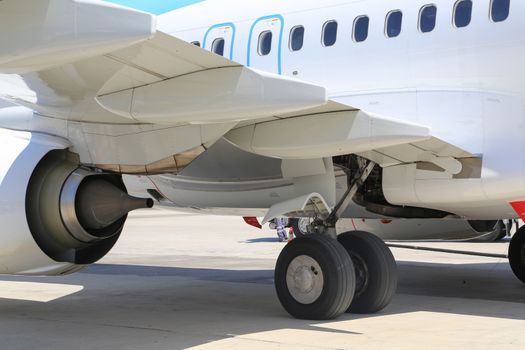 Close up of aircraft wheel and engine at the tarmac